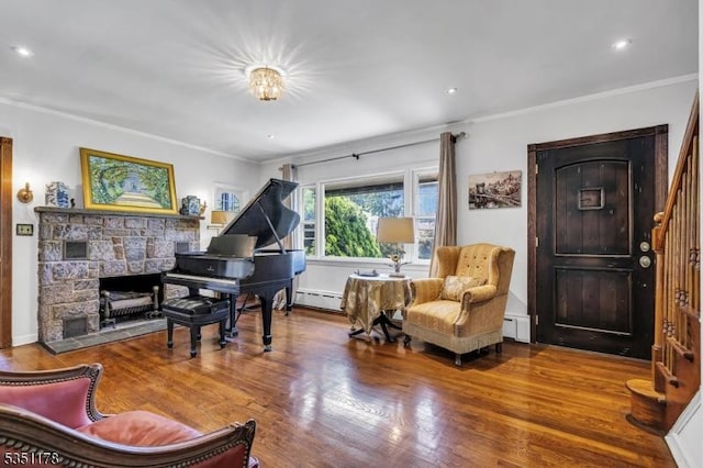 106 Anderson St, Raritan Boro, NJ 08869 - living area featuring a baseboard heating unit, crown molding, wood finished floors, a baseboard radiator, and a fireplace