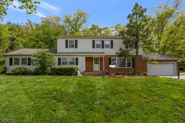traditional-style home with an attached garage, driveway, a front lawn, and brick siding