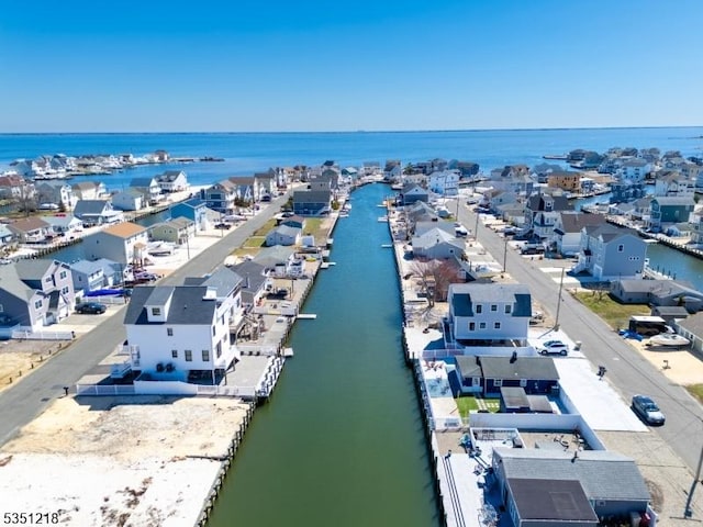 birds eye view of property with a water view and a residential view