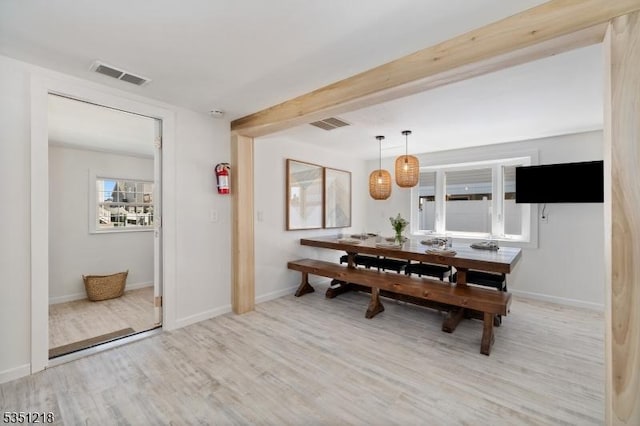 dining room with visible vents, baseboards, and wood finished floors