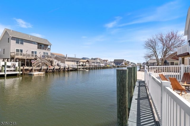 view of dock with a water view and a residential view
