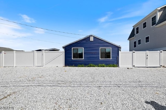 view of home's exterior featuring fence and a gate