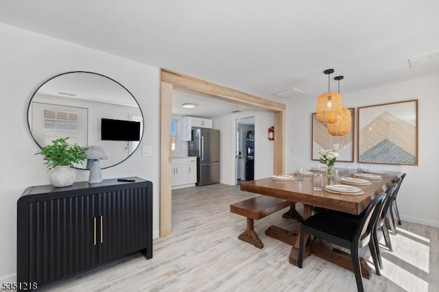 dining area with light wood-type flooring