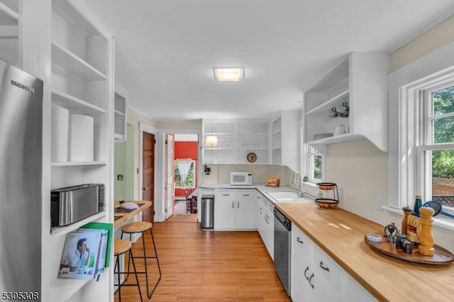 484 Rte 518, Montgomery Twp, NJ 08558 - kitchen featuring open shelves, white microwave, dishwasher, a sink, and light wood-type flooring