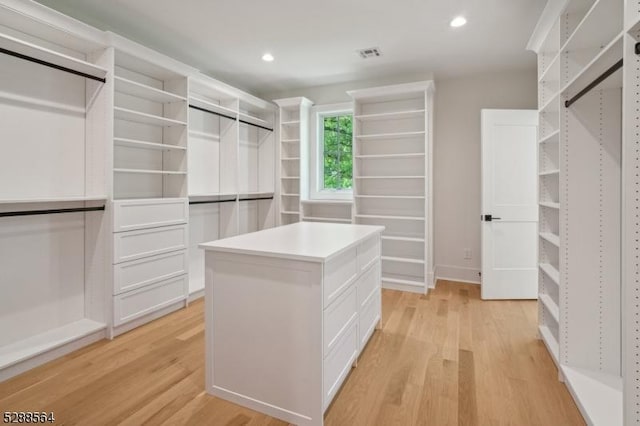 spacious closet with light wood-type flooring and visible vents