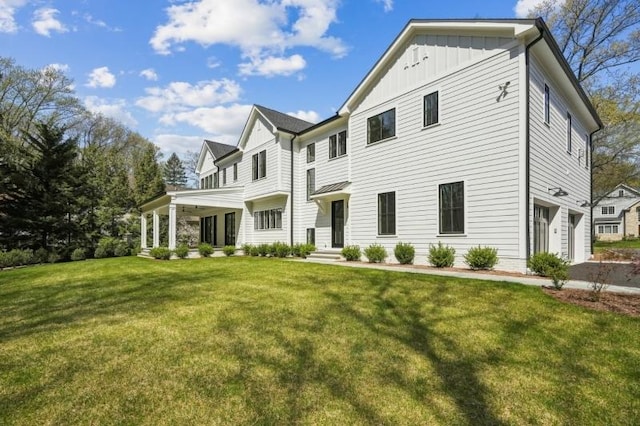 greek revival inspired property with board and batten siding, an attached garage, and a front yard