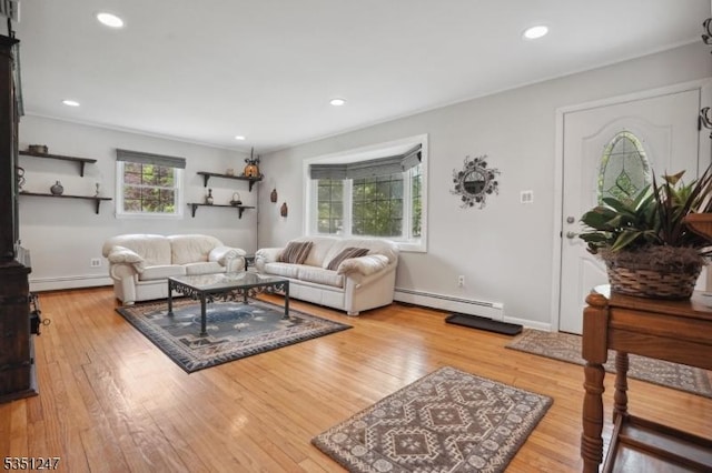 living room with a baseboard heating unit, a baseboard radiator, wood finished floors, and recessed lighting