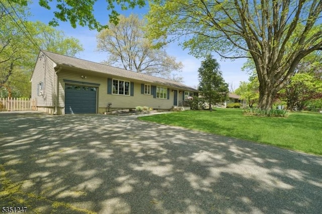 ranch-style home featuring an attached garage and driveway