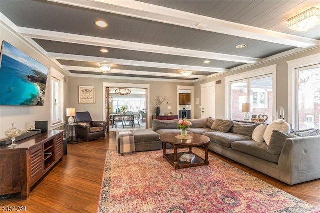 living area with beamed ceiling, wood finished floors, and recessed lighting