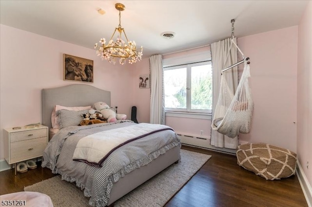 bedroom with baseboards, visible vents, a chandelier, baseboard heating, and wood finished floors