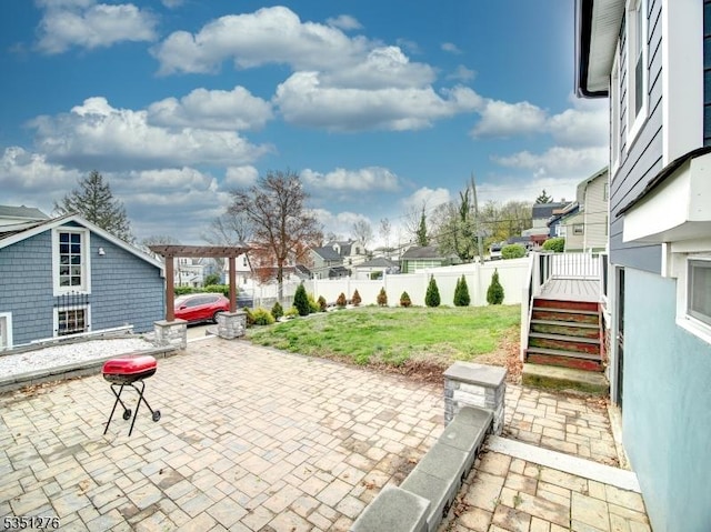 view of patio / terrace featuring fence and a residential view