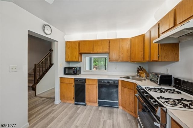 417 Penns Way, Bernards Twp, NJ 07920 - kitchen featuring black appliances, a sink, light wood-style floors, light countertops, and brown cabinets