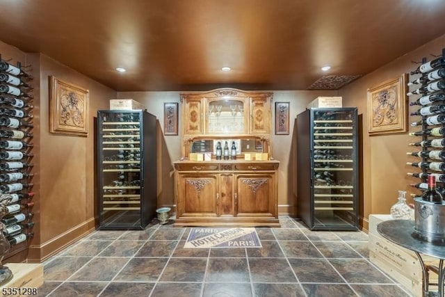 wine room with beverage cooler, recessed lighting, and baseboards