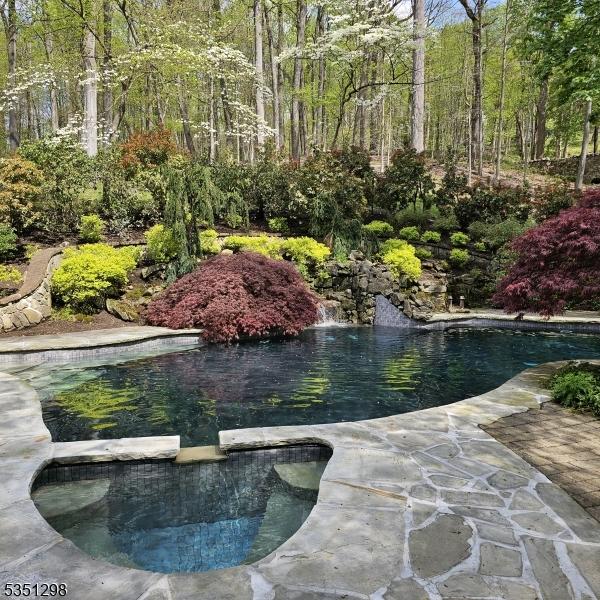 surrounding community featuring a small pond