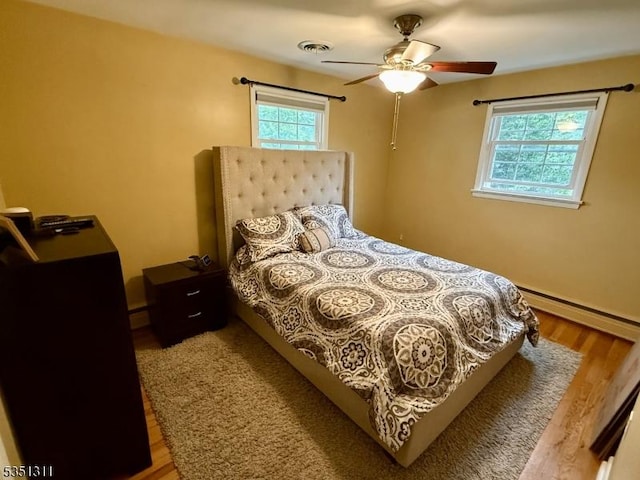 326 Spring Garden Rd, Holland Twp, NJ 08848 - bedroom featuring wood finished floors, a baseboard radiator, a ceiling fan, and baseboards