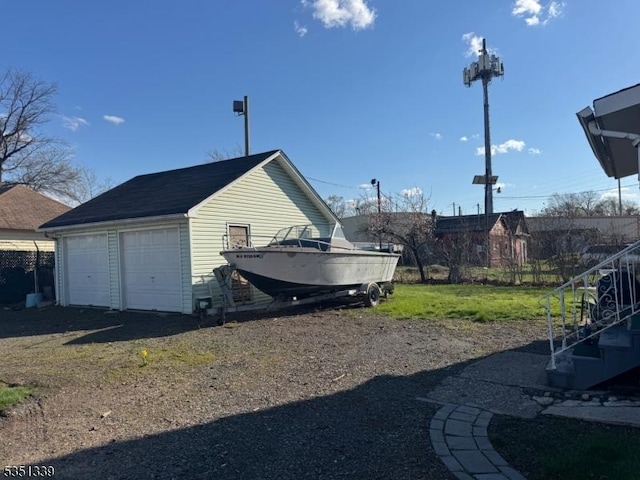 view of home's exterior with a garage and stairway