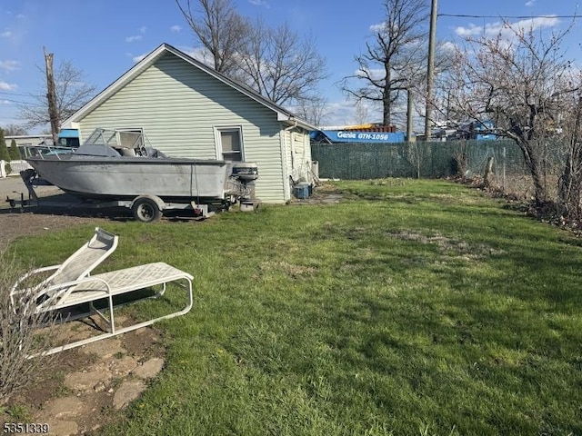 view of side of home with a yard