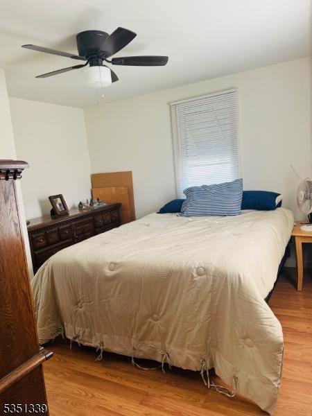 bedroom with wood finished floors and ceiling fan