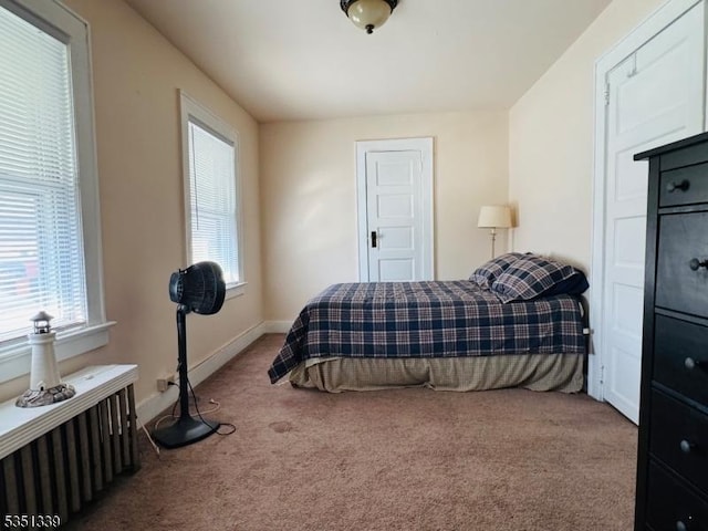 carpeted bedroom featuring baseboards