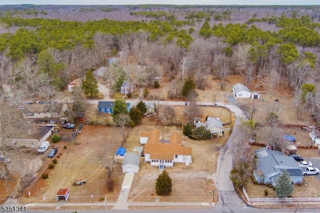 birds eye view of property with a wooded view