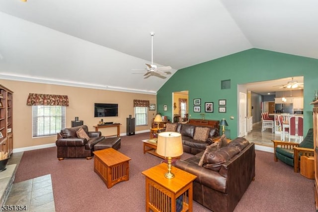 living room with ceiling fan, vaulted ceiling, and baseboards