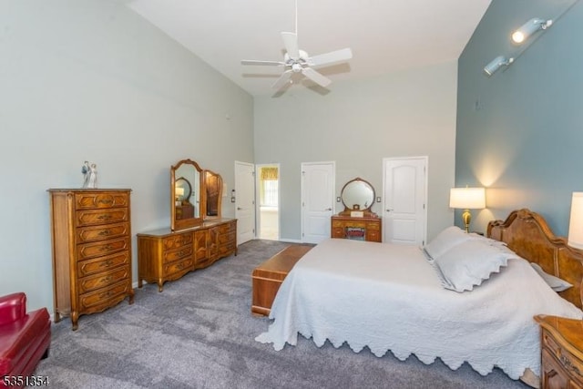 carpeted bedroom with high vaulted ceiling and ceiling fan