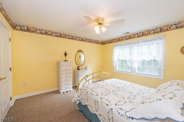 carpeted bedroom featuring visible vents, a ceiling fan, and baseboards