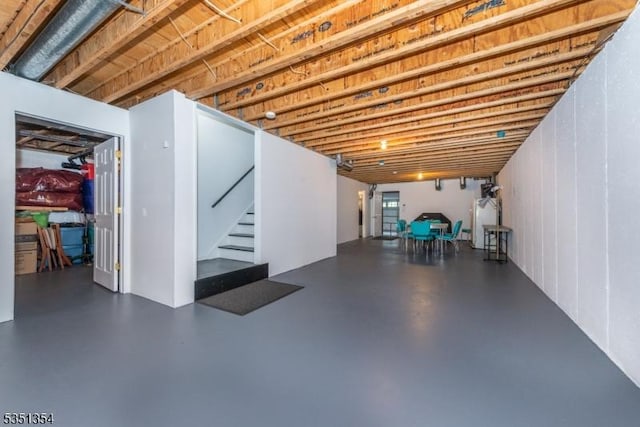 below grade area featuring water heater and stairs
