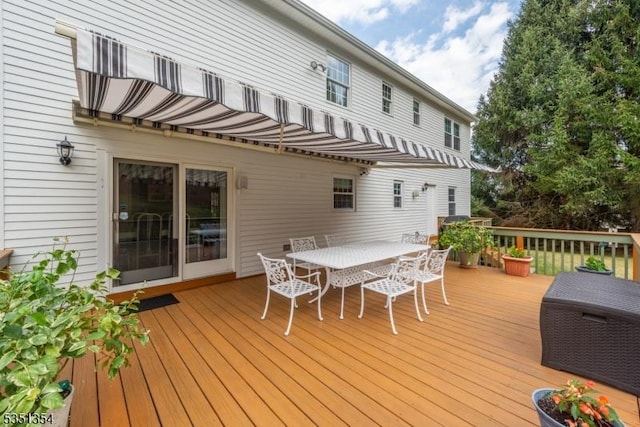 wooden terrace featuring outdoor dining area
