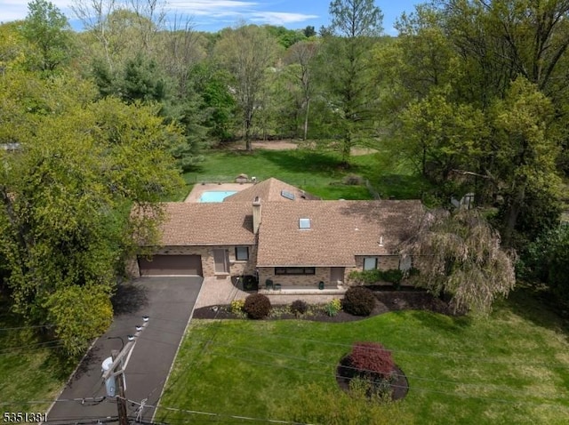 birds eye view of property with a forest view