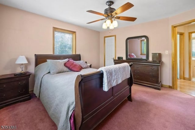 bedroom with a ceiling fan, light carpet, and multiple windows