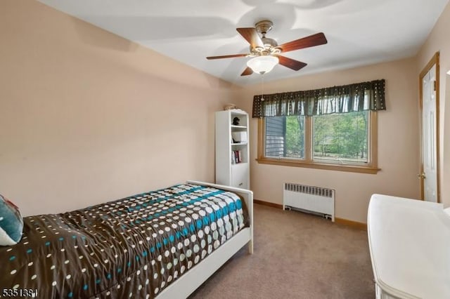 bedroom featuring baseboards, a ceiling fan, carpet, and radiator heating unit