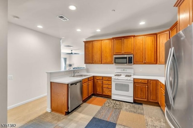 kitchen featuring brown cabinetry, stainless steel appliances, visible vents, and recessed lighting