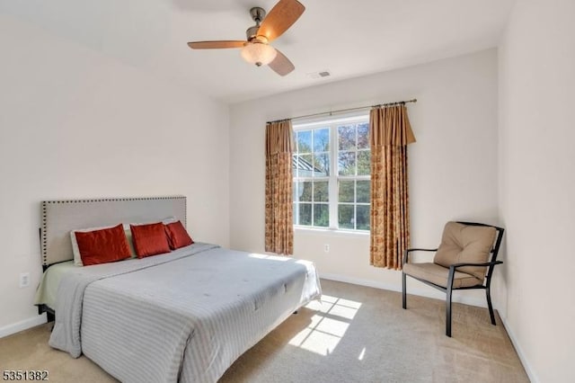 bedroom with light carpet, visible vents, and baseboards