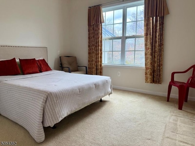 bedroom with carpet and baseboards