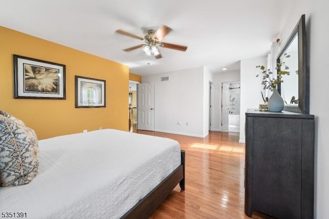 bedroom with baseboards, a ceiling fan, wood finished floors, and visible vents