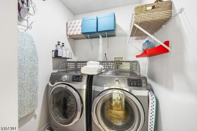 laundry room featuring separate washer and dryer and laundry area