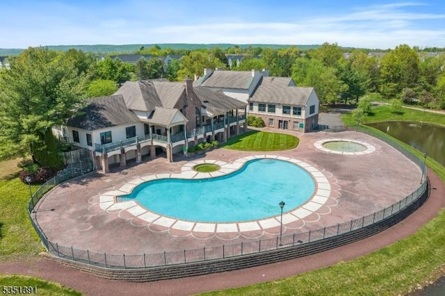 view of pool with a fenced in pool, an in ground hot tub, fence, and a patio