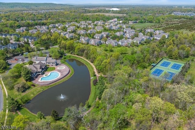 birds eye view of property featuring a water view, a residential view, and a forest view