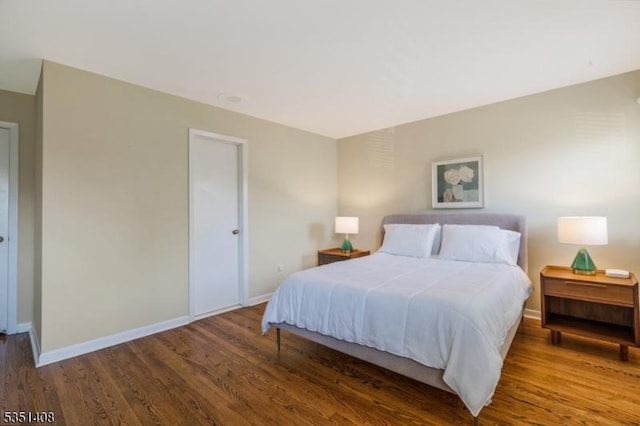 bedroom featuring baseboards and wood finished floors
