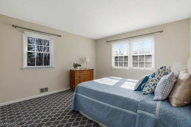 bedroom with baseboards, carpet, and visible vents