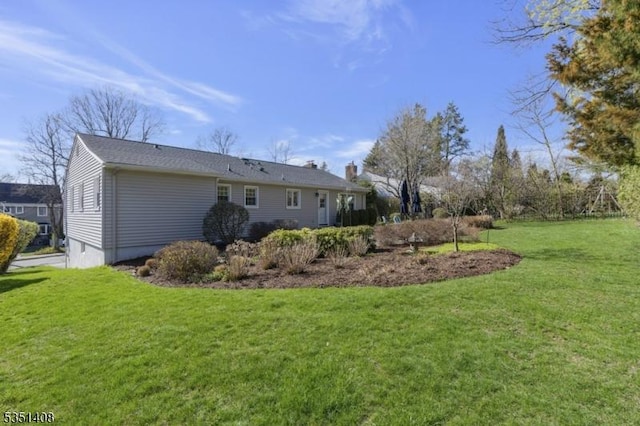rear view of property featuring a yard