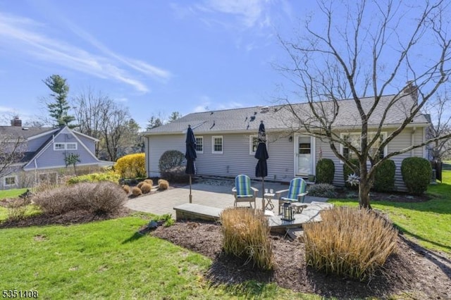 back of property featuring a lawn and a patio area