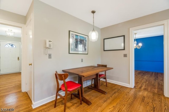 dining room with light wood-style floors and baseboards