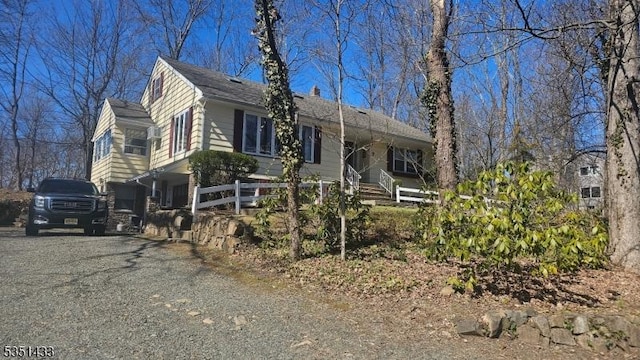 view of front of property featuring a shingled roof and driveway
