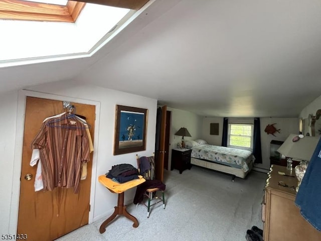 carpeted bedroom with lofted ceiling with skylight