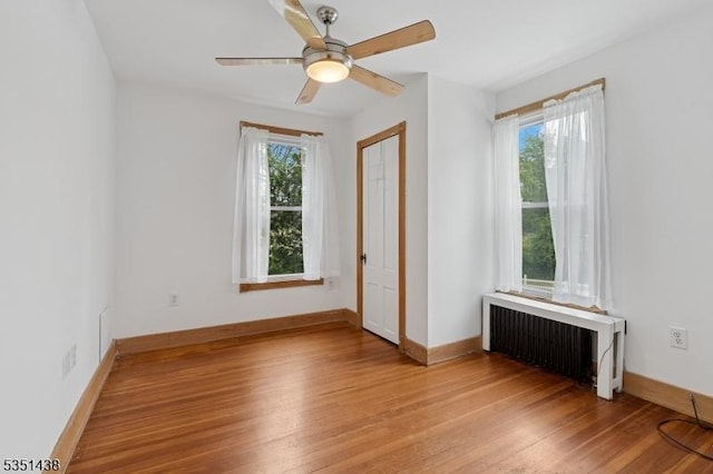 70 Highwood Ave, Englewood City, NJ 07631 - spare room with radiator, light wood-style floors, and a ceiling fan