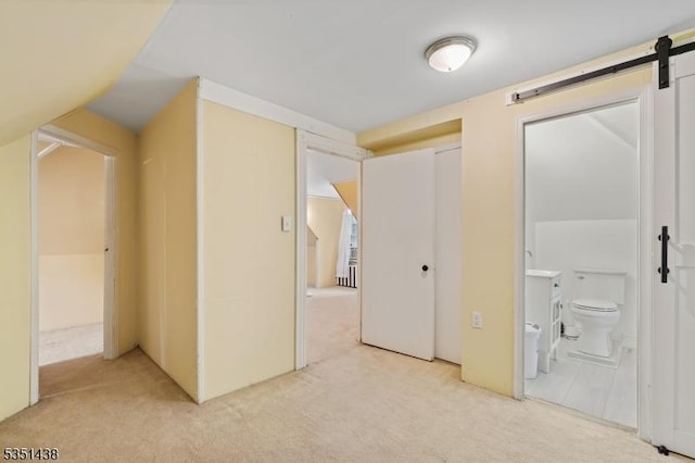70 Highwood Ave, Englewood City, NJ 07631 - unfurnished bedroom featuring light colored carpet, ensuite bathroom, and a barn door