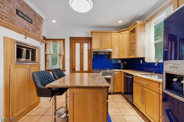 70 Highwood Ave, Englewood City, NJ 07631 - kitchen featuring appliances with stainless steel finishes, light tile patterned flooring, a center island, under cabinet range hood, and ornamental molding