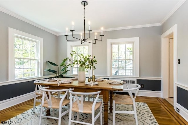 dining room with crown molding, wood finished floors, and a wealth of natural light